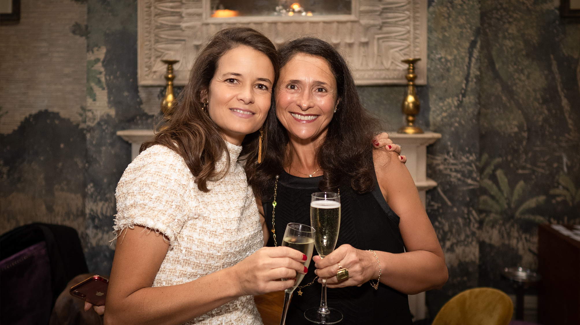 Visual aid: Two women posing at an event in a posh venue in London