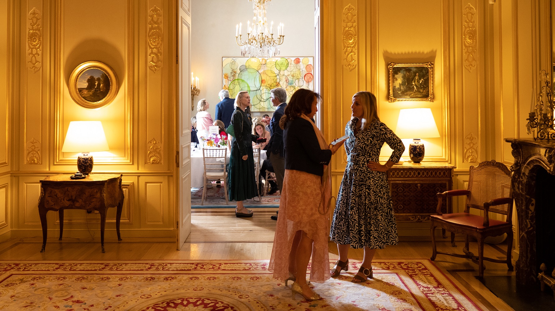 Visual aid: two women talking in the background at an event at the French Embassy in London