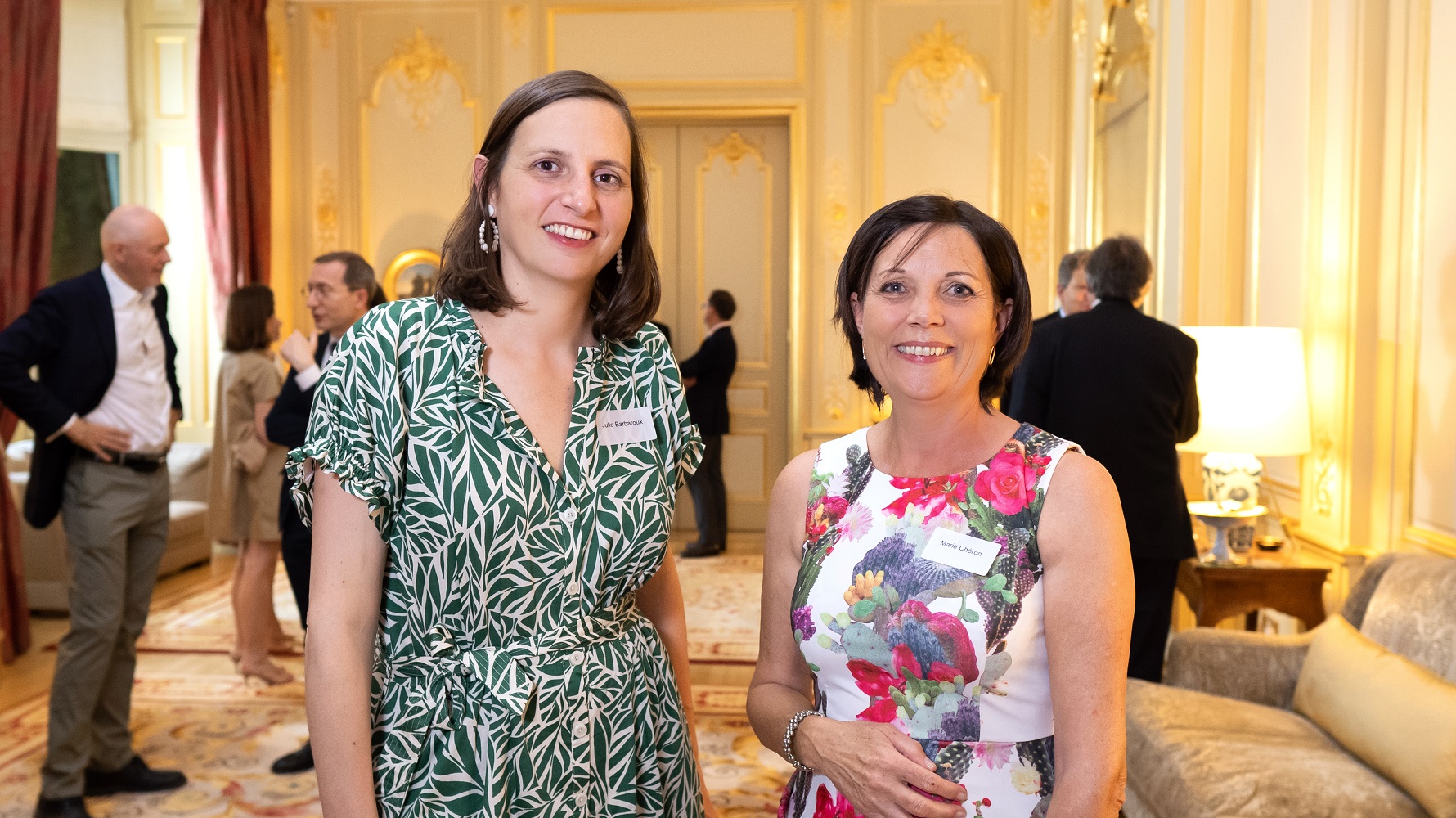Visual aid: two women posing at an event at the French Embassy in London