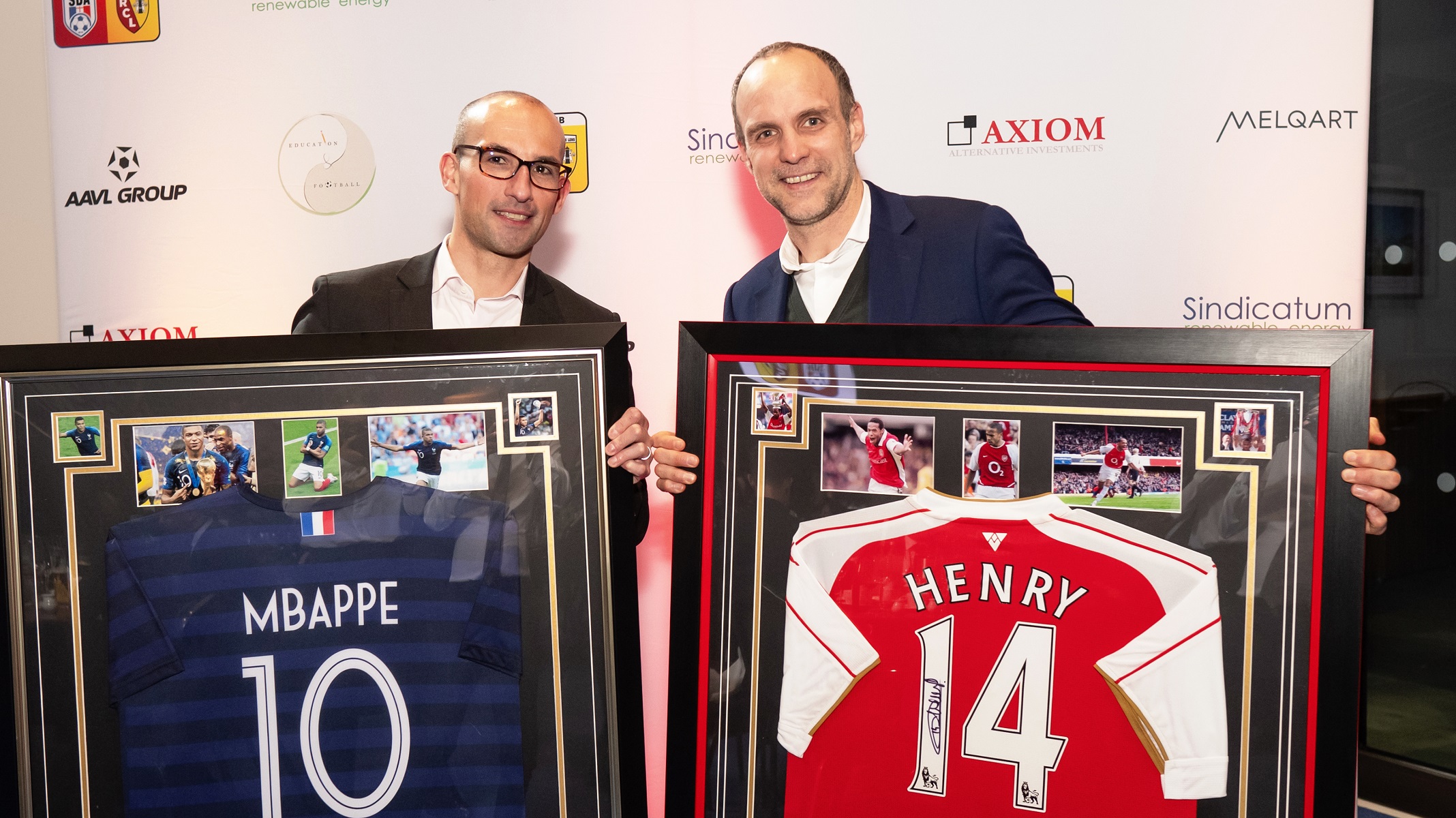 Visual aid: Two men holding prizes at a gala dinner in London